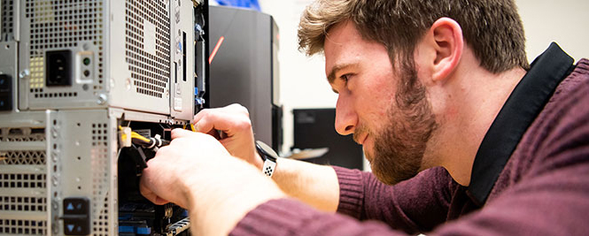 Student fixing a computer.